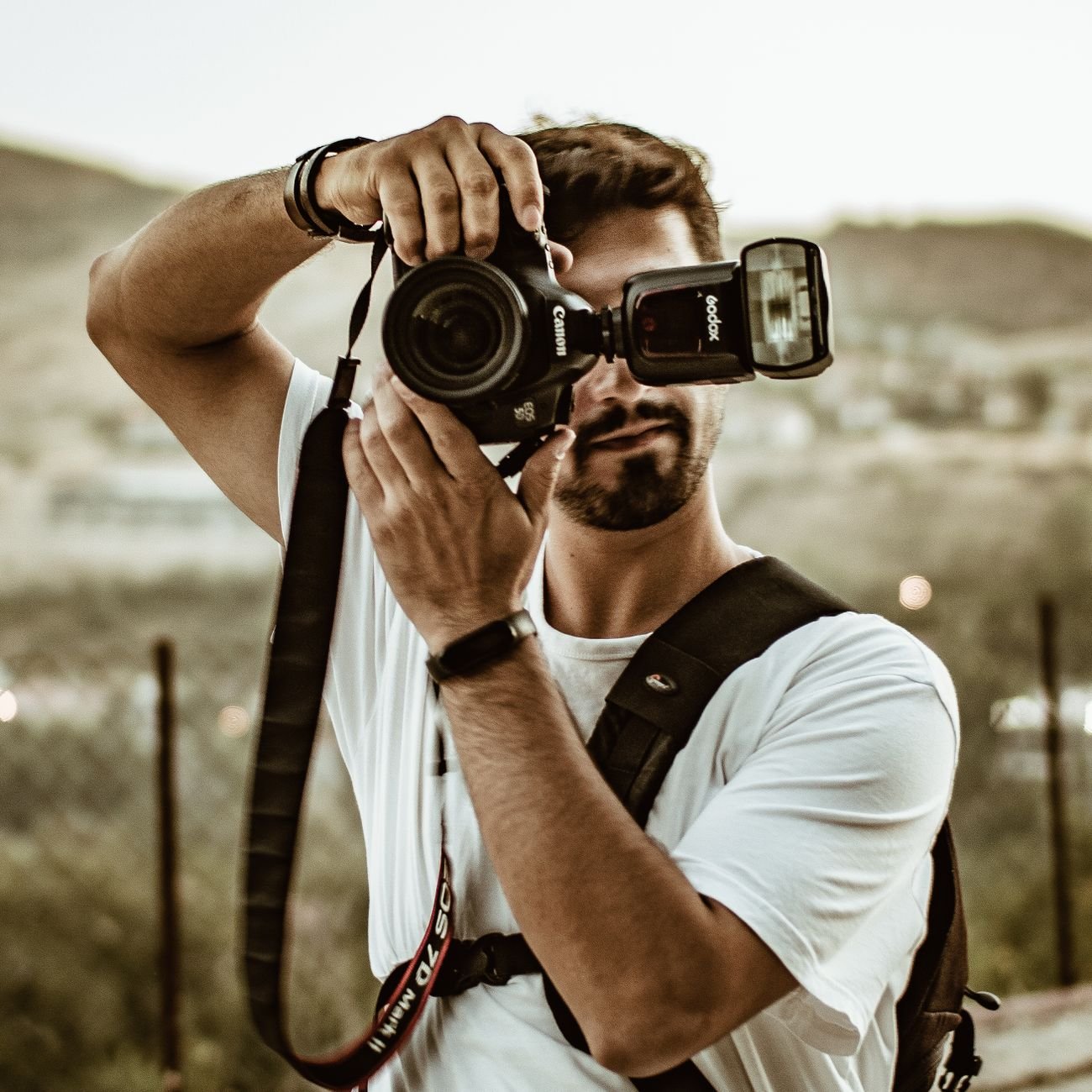 Photographer with camera capturing a moment outdoors